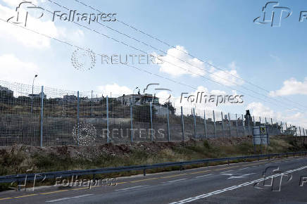 Israeli authorities encircle Palestinian town in West Bank with a fence, restricting free movement of residents