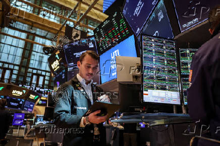 A trader works on the floor at the New York Stock Exchange (NYSE) in New York City