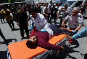 Palestinian casualties are brought into Al-Aqsa Martyrs Hospital, following an Israeli strike, in Deir al-Balah