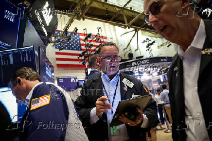 Traders work on the floor of the NYSE in New York