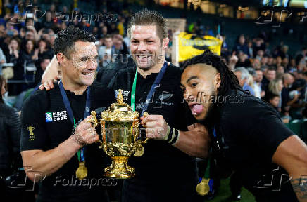 FILE PHOTO: Carter, McCaw and Nonu of New Zealand pose with the Webb Ellis trophy after winning the Rugby World Cup Final against Australia at Twickenham in London