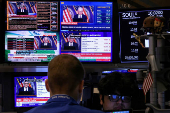 Traders work, as screens broadcast a news conference by U.S. Federal Reserve Chair Jerome Powell following the Fed rate announcement, on the floor of the NYSE in New York