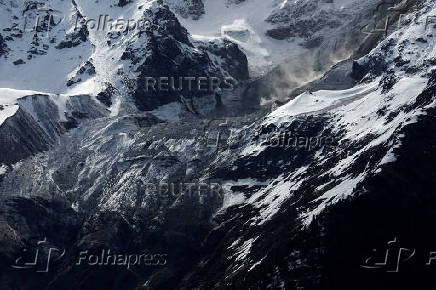 Debris and dust from a crumbling glacier that partially collapsed and tumbled onto the village of Blatten