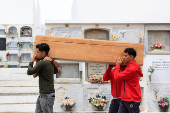 People carry the body of 12-year-old migrant girl Fatoumatta Banaro during her burial, after the wooden boat she was traveling on sank in the port of La Restinga
