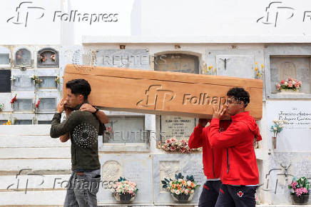 People carry the body of 12-year-old migrant girl Fatoumatta Banaro during her burial, after the wooden boat she was traveling on sank in the port of La Restinga