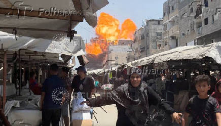 Smoke and flames rise from a house hit by an Israeli strike in Gaza City