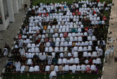 Palestinians from Gaza attend Eid al-Adha prayers, at Al Thumama Complex,  in Doha