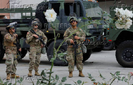 California National Guard troops stand outside the Edward R. Roybal federal building, in Los Angeles