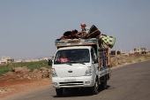 People travel on land between Deraa and Sweida after Druze unrest