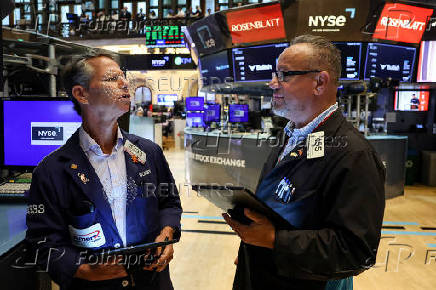 Traders work on the floor of the NYSE in New York