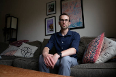Ian Morgan, an employee at the National Institute for General Medical Sciences, sits for a portrait in Bethesda, Maryland