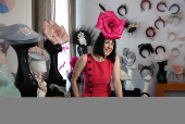Milliner Merve Bayindir wears one of her hat creations as she speaks to Reuters ahead of the Ascot horse racing festival, in London