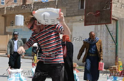 Yemenis receive food aid in Sana'a, distributed by Mona Relief agency