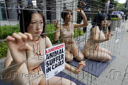 PETA supporters stage a protest during Ajinomoto annual shareholders' meeting