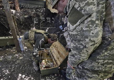 Ukrainian servicemen hold a position in the Kharkiv region