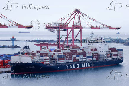 Containers are stacked on a Taiwanese shipping firm Yang Ming Marine Transport Corp container ship in Keelung