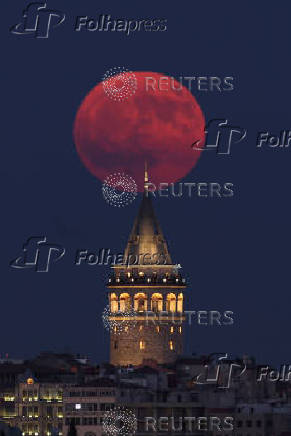 A full moon, known as the Buck Moon, rises over the Galata Tower in Istanbul