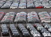 Honda and Tesla vehicles are lined up at a vehicle storage yard at an industrial port in Yokohama