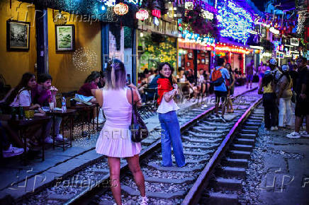 Tourists visit Hanoi Train Street, one of the famous tourist destinations in Hanoi