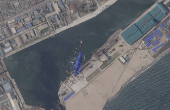 A satellite image shows a North Korean warship covered with a blue tarp after an accident that occurred during its launch at the shipyard in Chongjin