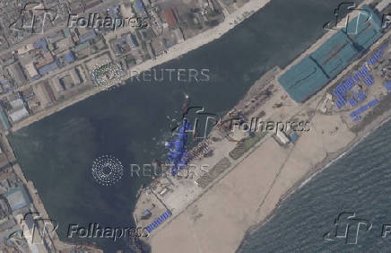 A satellite image shows a North Korean warship covered with a blue tarp after an accident that occurred during its launch at the shipyard in Chongjin