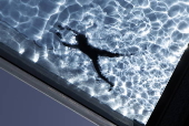 People swim in the Sky Pool during hot weather in London