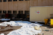 Covered bodies lie on the ground in Sweida