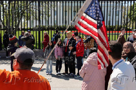 Donald Trump impersonator Ed Weiskopf poses for a picture in front of the White House in Washington