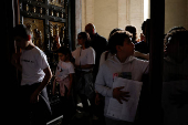 Faithful touch the Holy Door in St. Peter's Basilica at the Vatican
