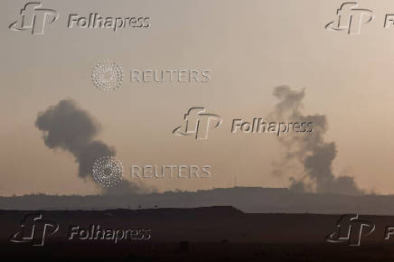 Smoke rises following an Israeli air strike, near the Israel-Gaza border