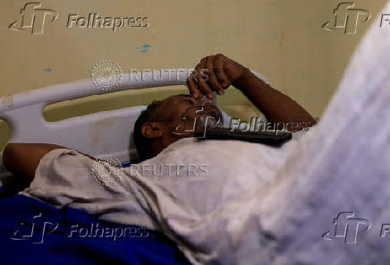 A dengue fever patient rests at a hospital in Khartoum