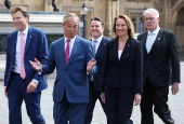 Britain?s Reform Party leader Farage walks with fellow Reform MPs, including newly elected MP Pochin into Houses of Parliament in London