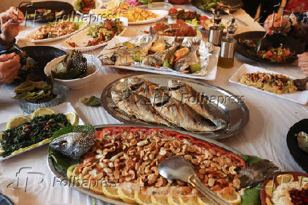 Food is placed on a table at Zainab Khalifeh's restaurant, a Lebanese who turned a part of her home into a restaurant and called it 'Zainab's table' in the town of Sarafand,
