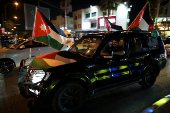 Jordanians celebrate as Jordan qualified for the World Cup for the first time, after 3-0 win over Oman, in Amman