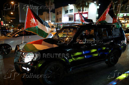 Jordanians celebrate as Jordan qualified for the World Cup for the first time, after 3-0 win over Oman, in Amman
