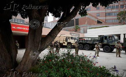 California National Guard troops stand outside the Edward R. Roybal federal building, in Los Angeles
