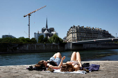 People enjoy a warm and sunny spring day in Paris