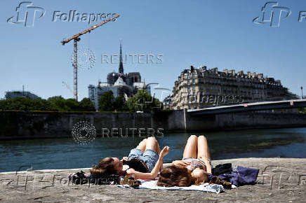 People enjoy a warm and sunny spring day in Paris