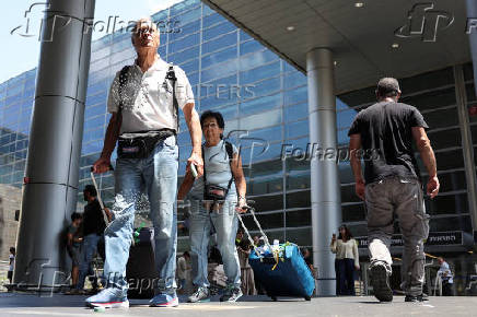 Israeli nationals arrive at Ben Gurion International airport from abroad, in Tel Aviv