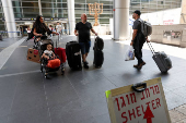 Israeli nationals arrive at Ben Gurion International airport from abroad, in Tel Aviv