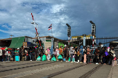 Cambodian people queue to cross the closed Khlong Luek Border Checkpoint