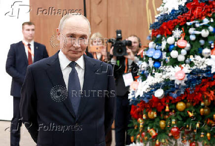 Russian President Vladimir Putin meets with volunteers in Moscow