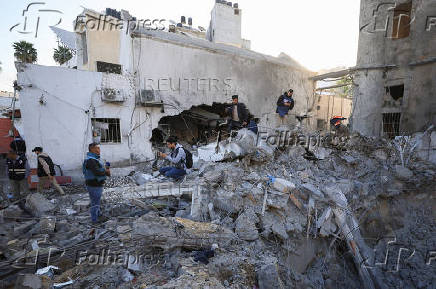 Palestinians inspect damage inside the Al-Ahli Arab Baptist Hospital in Gaza City
