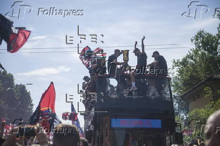 Players of Bologna FC and fans celebrate in Bologna