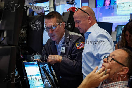 Traders work on the floor of the NYSE in New York
