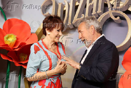 People walk a yellow carpet during the premiere of 'The Wizard of Oz' in Las Vegas