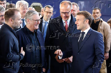 Emmanuel Macron, Keir Starmer and Friedrich Merz arrive at Kyiv railway station