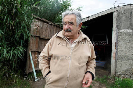 FILE PHOTO: Presidential candidate of ruling party Frente Amplio former left-wing guerrilla fighter Jose Mujica chats in his farm in Montevideo outskirts