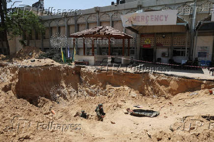 Israeli soldiers walk out from a tunnel underneath the European Hospital in Khan Younis at the Gaza Strip,