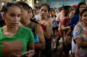 Residents affected by monsoon rains queue for relief following monsoon rains in Quezon City
